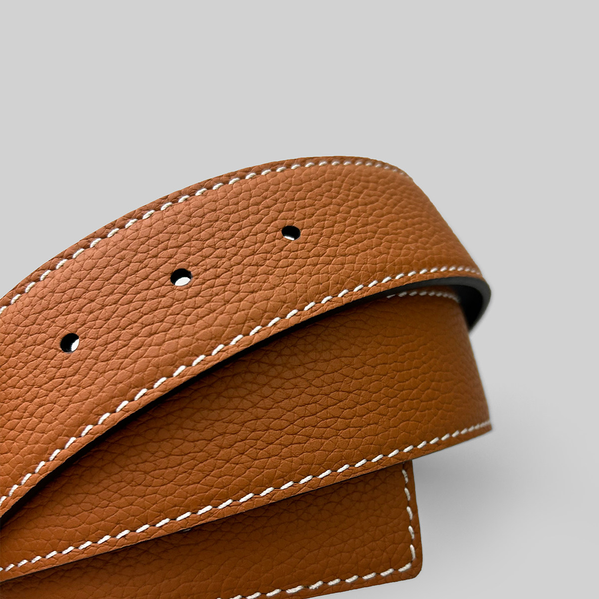 Brown pebble grain leather belt strap with white stitching