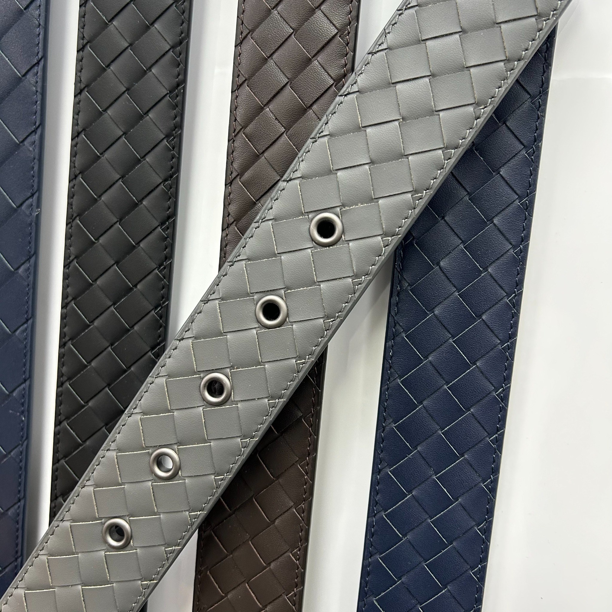 Gray woven-pattern belt strap with adjustable eyelets