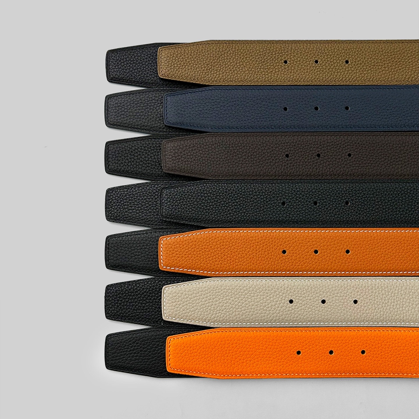 Flat lay of pebble grain leather belt straps in multiple colors