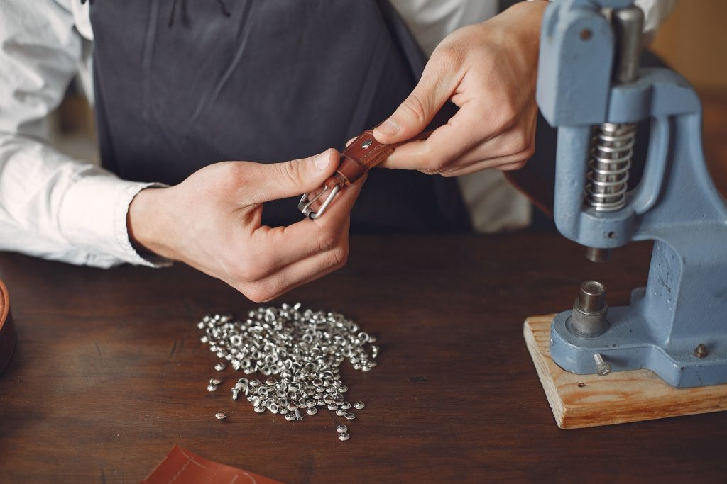 Private label leather belts being made in a leather workshop